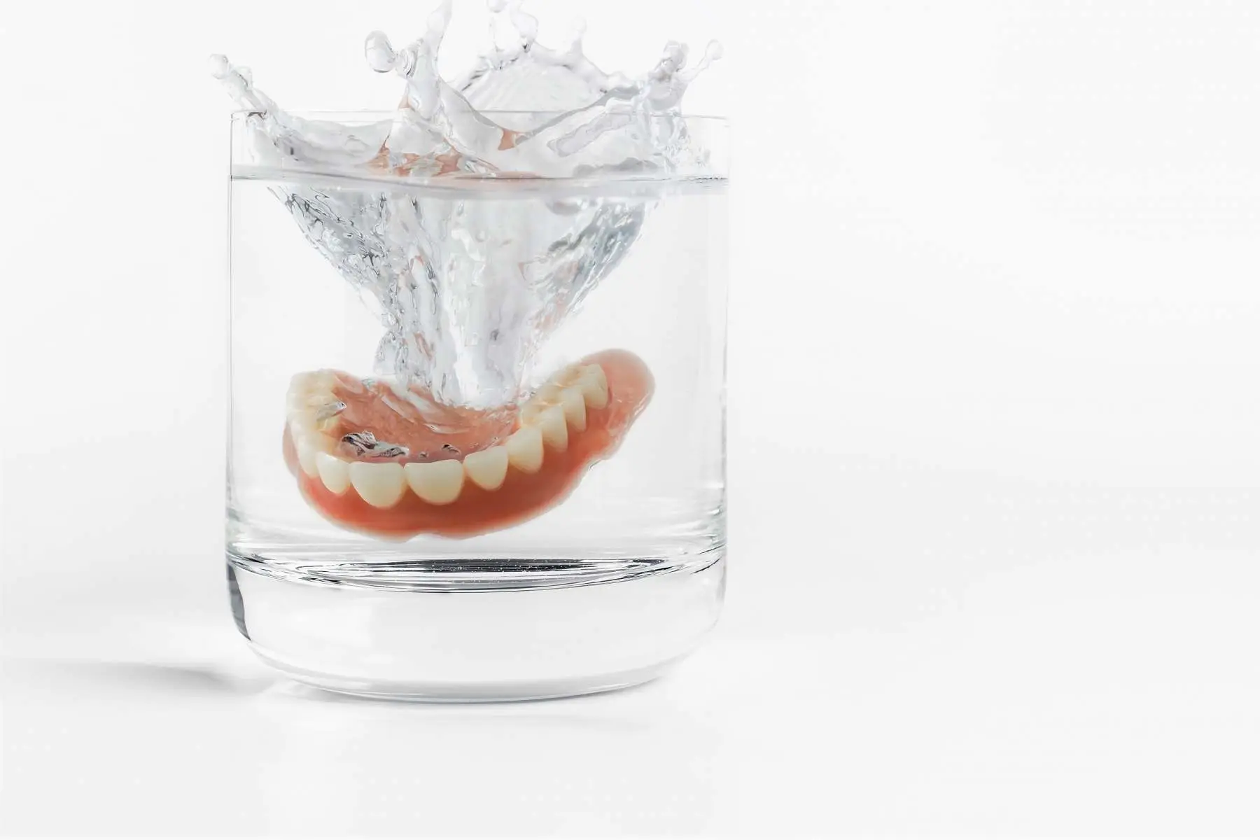 Full denture in a glass of water Chrome Cast denture repairs Crowborough